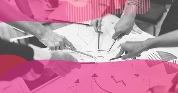 A team’s hands pointing at charts on a sheet while planning SMART goals and lead prospecting.