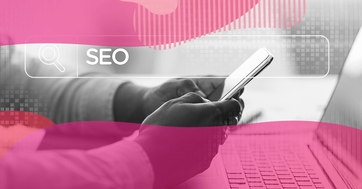 Person holding a smartphone in front of a laptop, with the word “SEO” highlighted in a digital search bar.