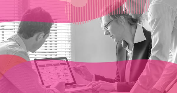 Team meeting reviewing tasks on a laptop, illustrating how to manage activities in HubSpot CRM.