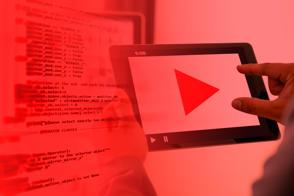 Person holding tablet with play button highlighted, superimposed on a screen with codes, representing the integration between technology and audio marketing.