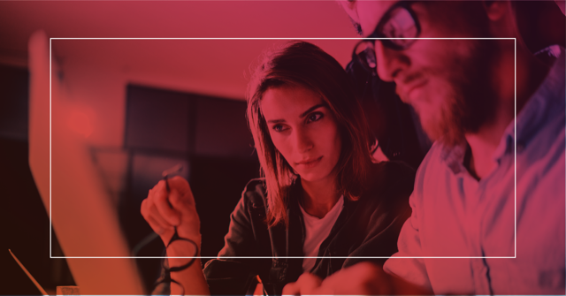 Woman and man analyzing data on a notebook with concentrated expression, representing marketing automation strategies.