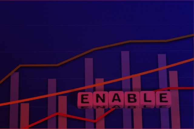 Image with bar graphs and ascending lines, with cubes forming the word "ENABLE", representing the concept of Sales Enablement and sales growth.
