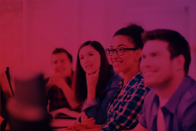 Group of students smiling in a learning environment, representing connection with the brand.