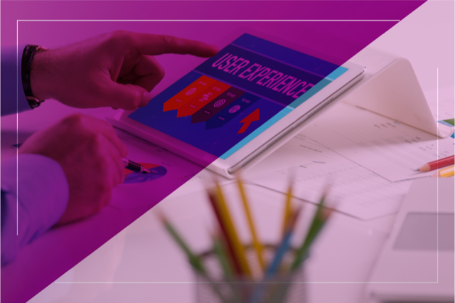 Person interacting with a tablet displaying the message "User Experience", representing the importance of user experience in increasing enrollments.