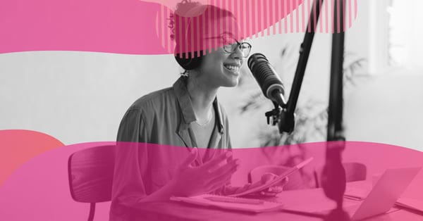 Smiling woman in a recording studio speaking into a professional microphone with headphones on, representing podcast production.
