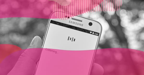 Hand holding a Samsung smartphone with the voice command screen active and the message “Listening,” representing Google voice search on mobile devices.