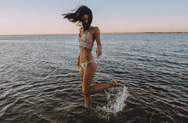 Moça com roupa de banho no mar