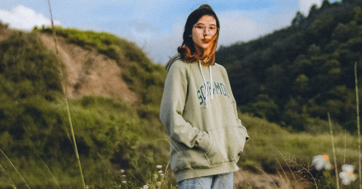 woman in a coat in a field